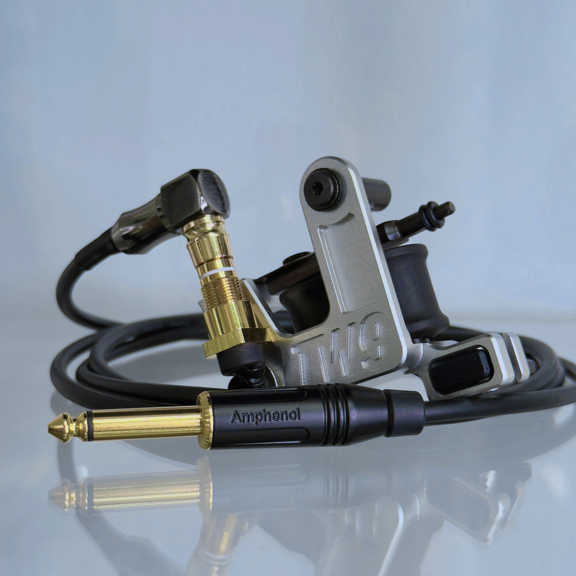 LEBA V2 2.0 silver coil tattoo machine with RCA and clipcord connection, includes 90-degree cable